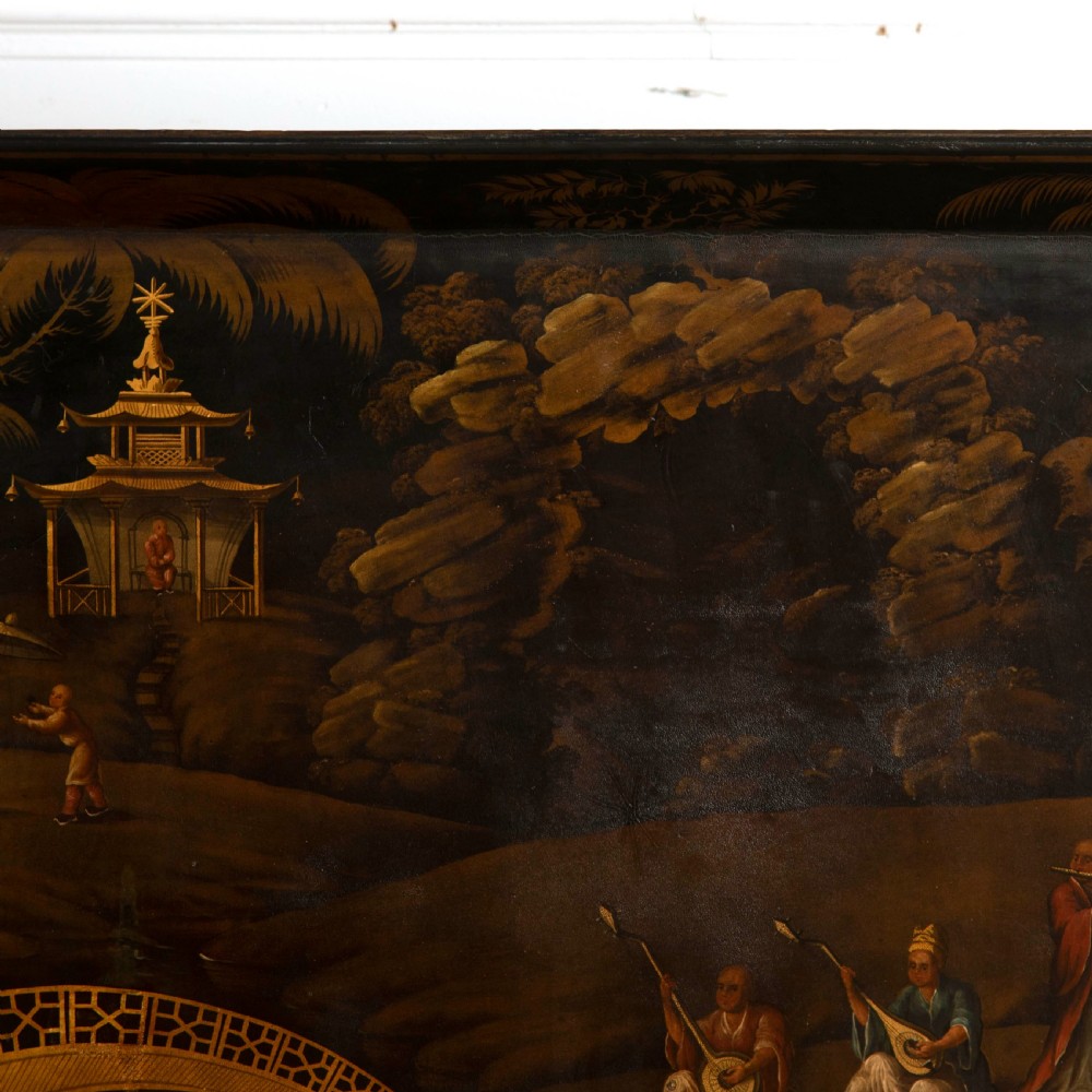 A Regency black lacquered and gilded papier-mache Chinoiserie tray featuring hand-painted pagodas and figures mounted on a dark wooden stand. View V