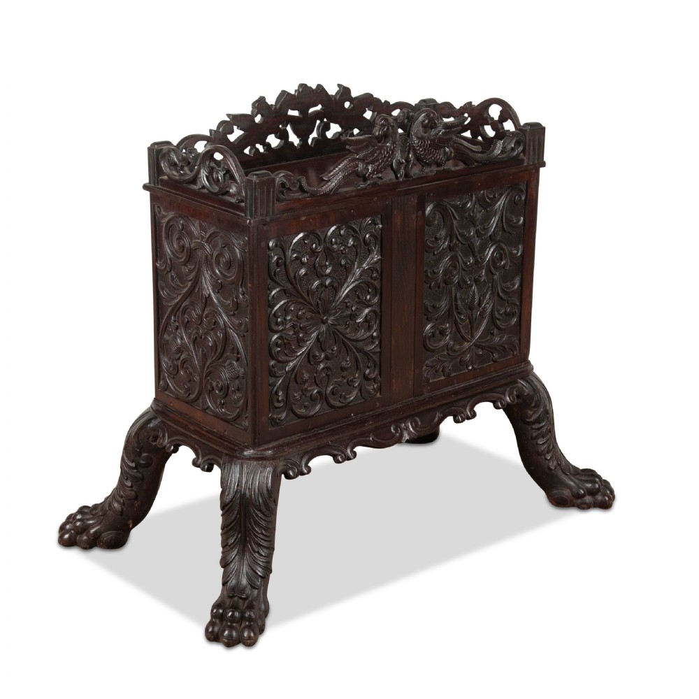 A small 19th-century dark hardwood Chinese cabinet featuring floral relief carving on double doors, an ornate carved cresting gallery, and heavy carved cabriole legs. View III