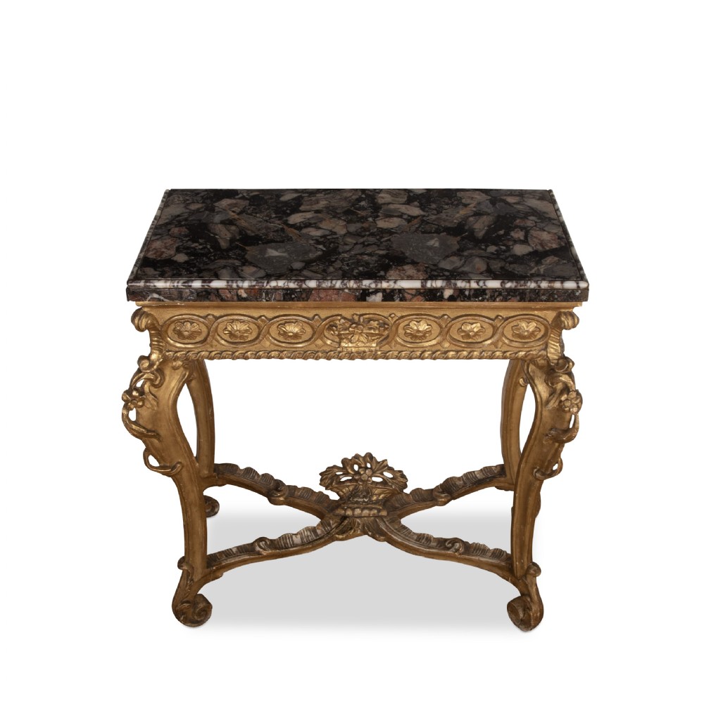 An 18th-century giltwood console table featuring a dark mottled marble top, carved apron with rosette motifs, and cabriole legs linked by an X-shaped stretcher. View IV