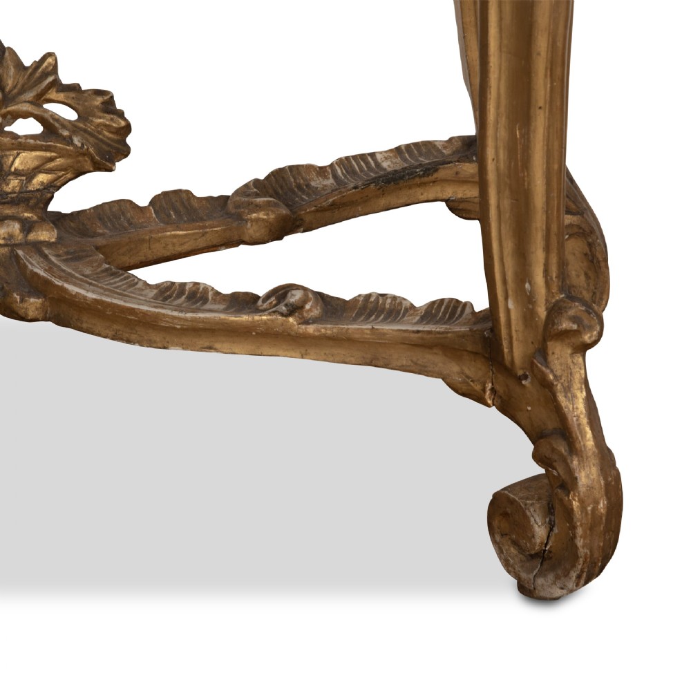 An 18th-century giltwood console table featuring a dark mottled marble top, carved apron with rosette motifs, and cabriole legs linked by an X-shaped stretcher. View XIII