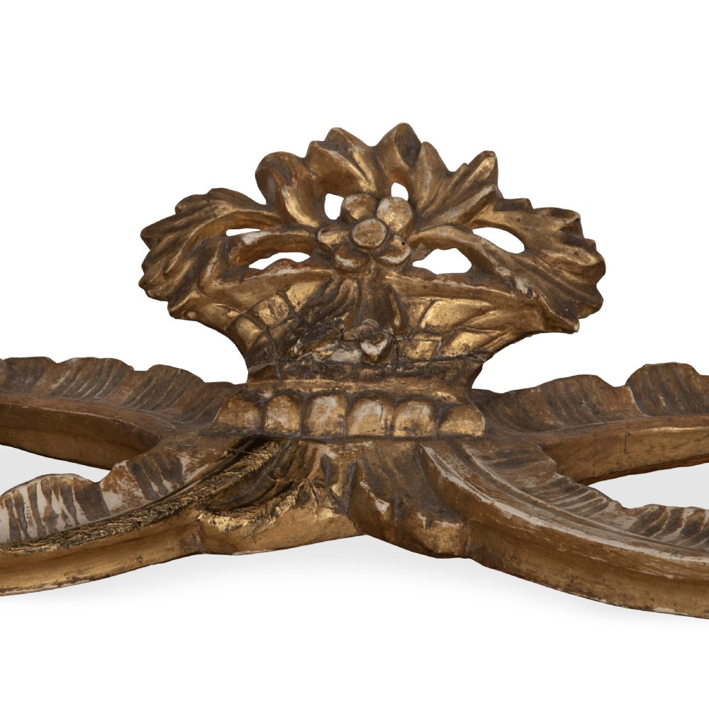 An 18th-century giltwood console table featuring a dark mottled marble top, carved apron with rosette motifs, and cabriole legs linked by an X-shaped stretcher. View XIV