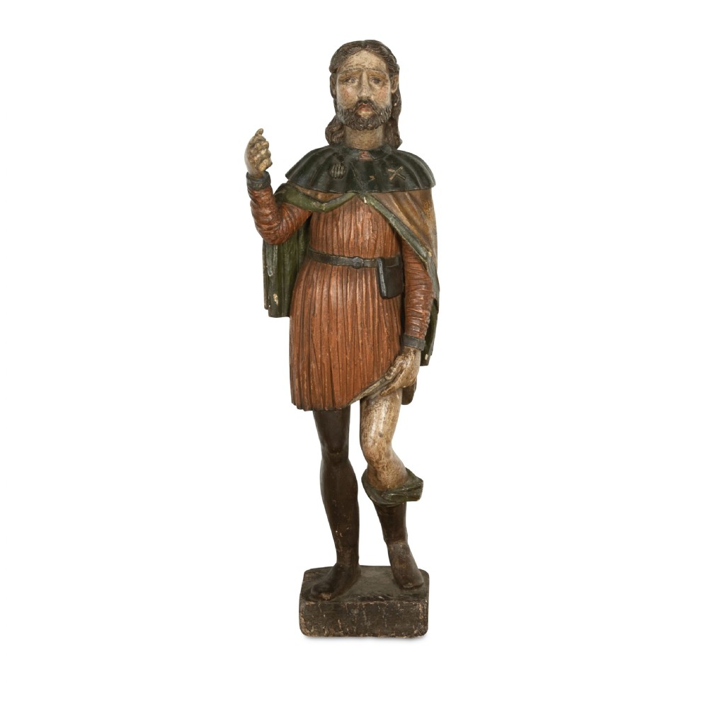 An 18th-century carved wooden polychrome statue depicting Saint Roch standing on a square timber base.