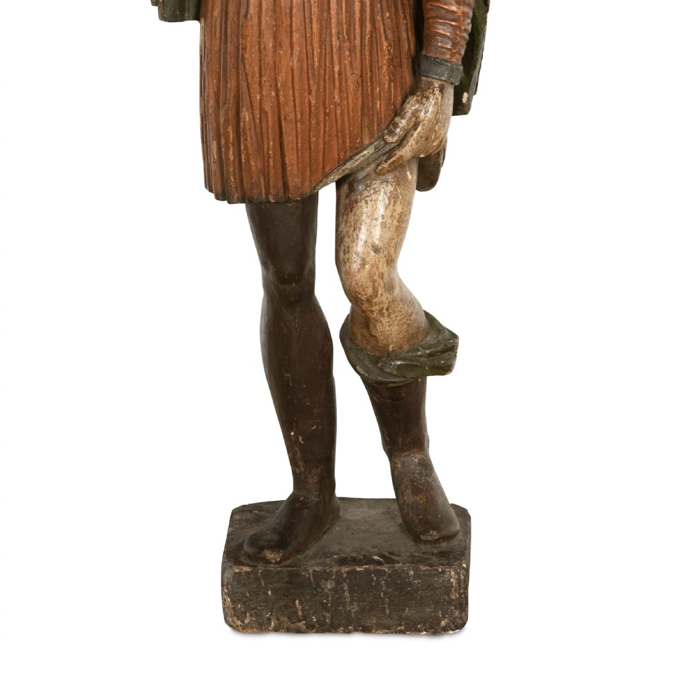 An 18th-century carved wooden polychrome statue depicting Saint Roch standing on a square timber base. View VII