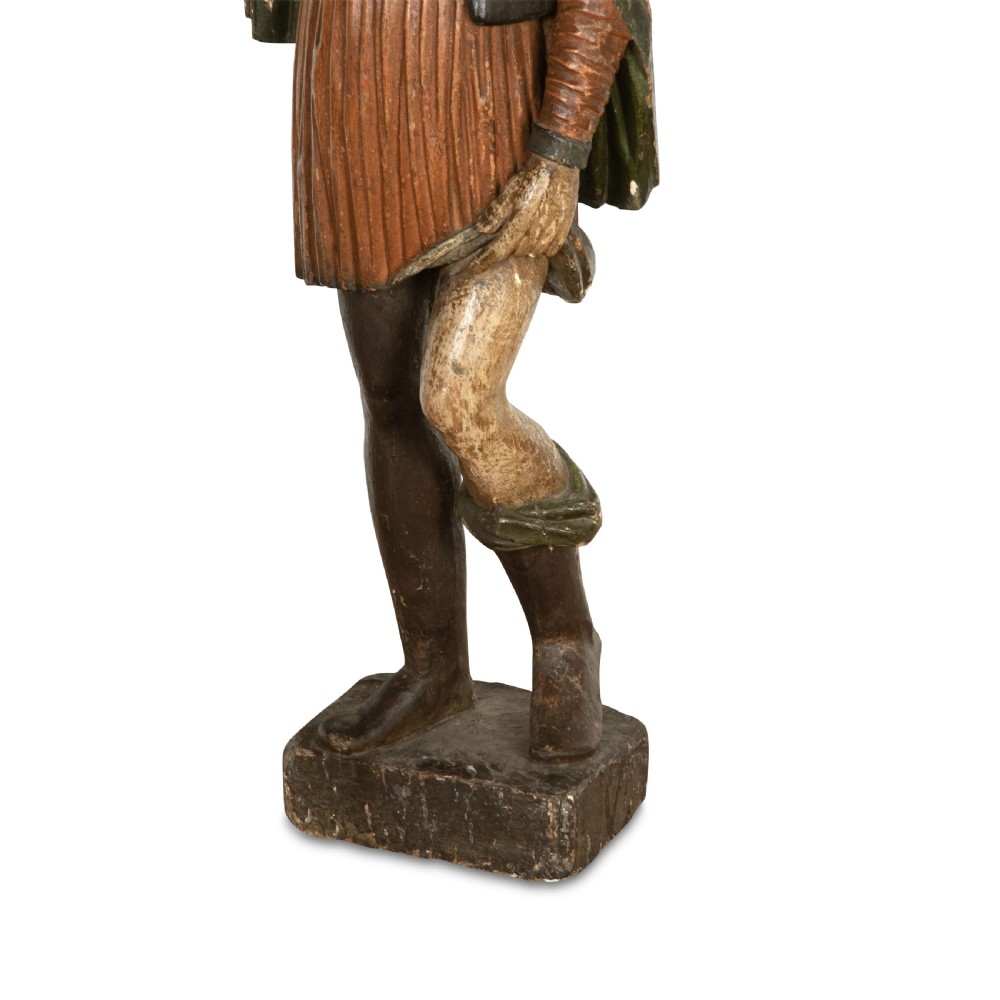 An 18th-century carved wooden polychrome statue depicting Saint Roch standing on a square timber base. View IX