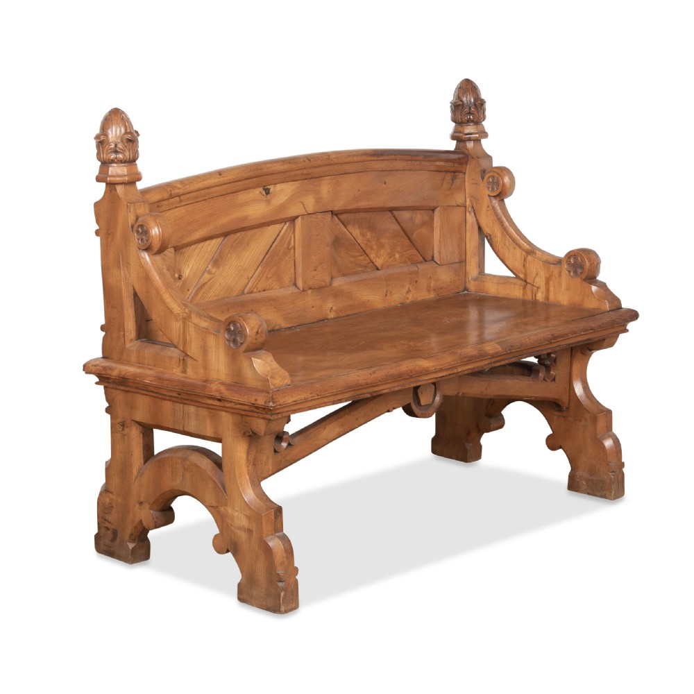 A 19th-century carved elm bench featuring pointed finial posts, a geometric panelled backrest, and trefoil cut-outs on the lower frame. View II