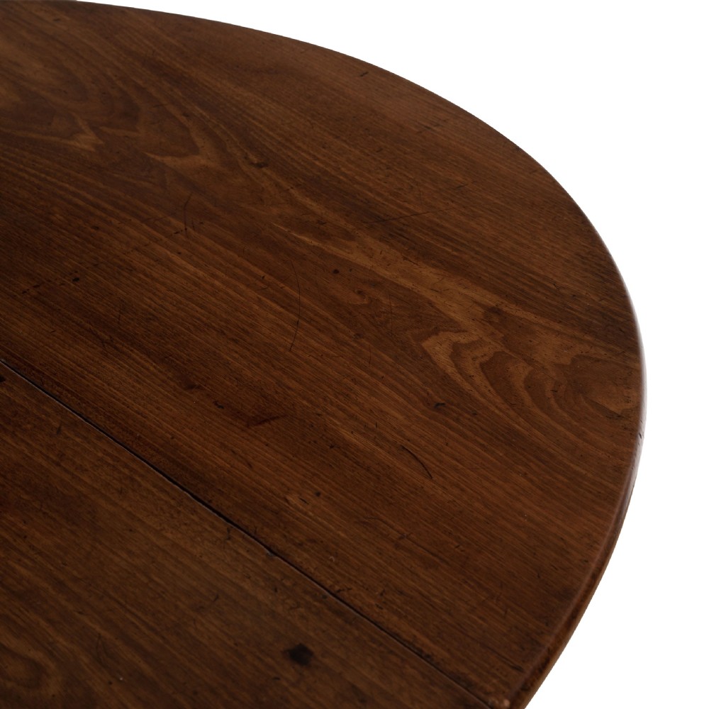 A dark brown Georgian walnut drop flap dining table featuring turned legs, bottom stretchers, an end drawer, and hinged oval leaves. View IV