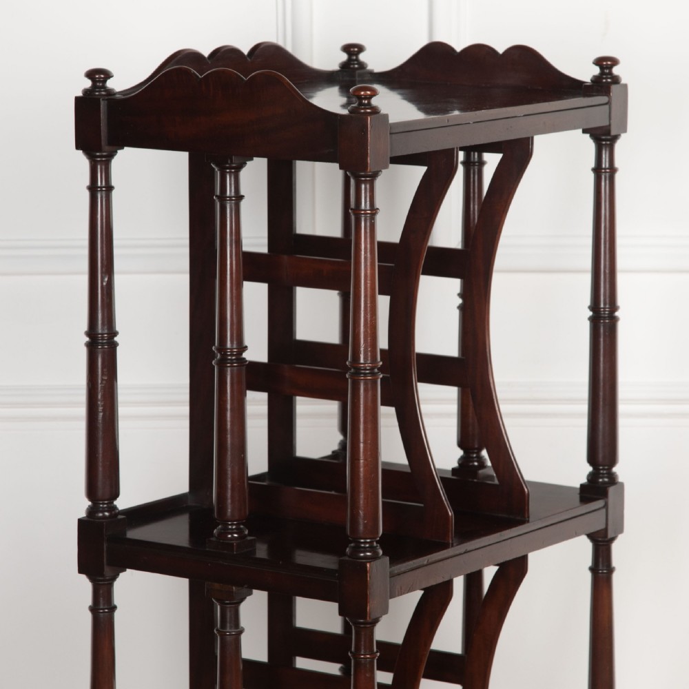 A tall dark mahogany etagere featuring three open shelves, vertical music dividers, turned spindle supports, a top gallery rail, and a single bottom drawer with turned wooden knobs. View III