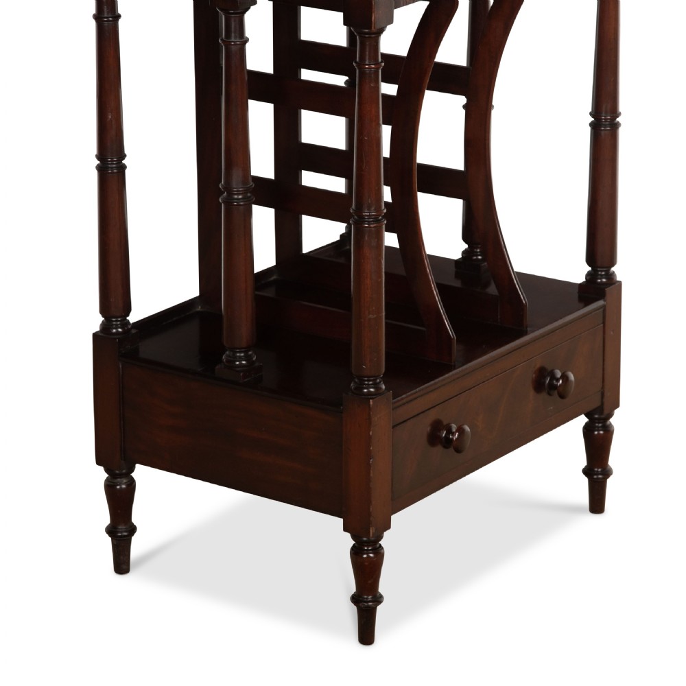 A tall dark mahogany etagere featuring three open shelves, vertical music dividers, turned spindle supports, a top gallery rail, and a single bottom drawer with turned wooden knobs. View IV