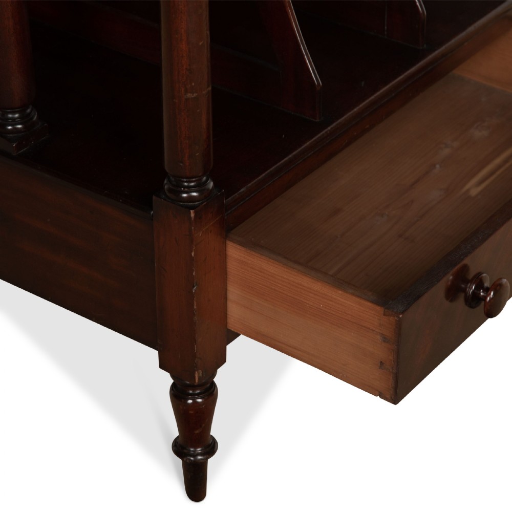 A tall dark mahogany etagere featuring three open shelves, vertical music dividers, turned spindle supports, a top gallery rail, and a single bottom drawer with turned wooden knobs. View V