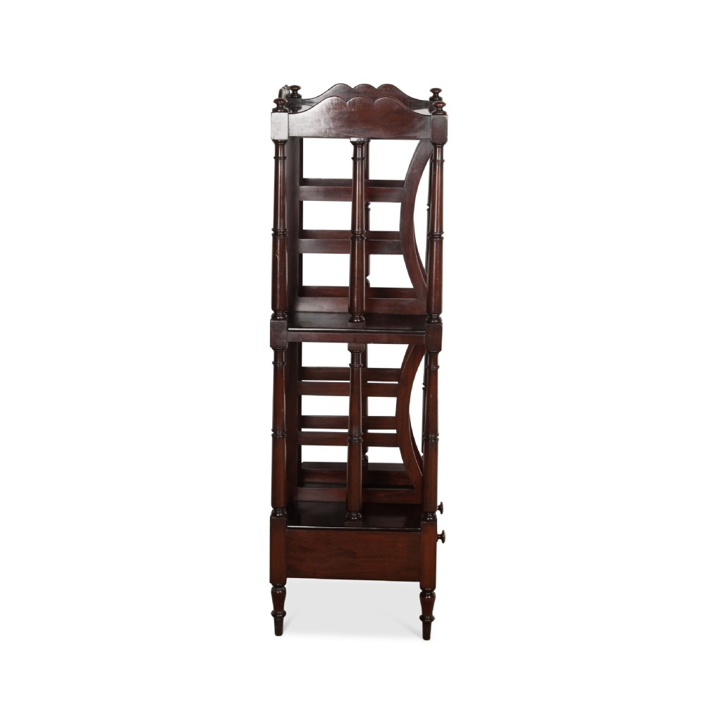 A tall dark mahogany etagere featuring three open shelves, vertical music dividers, turned spindle supports, a top gallery rail, and a single bottom drawer with turned wooden knobs. View VI