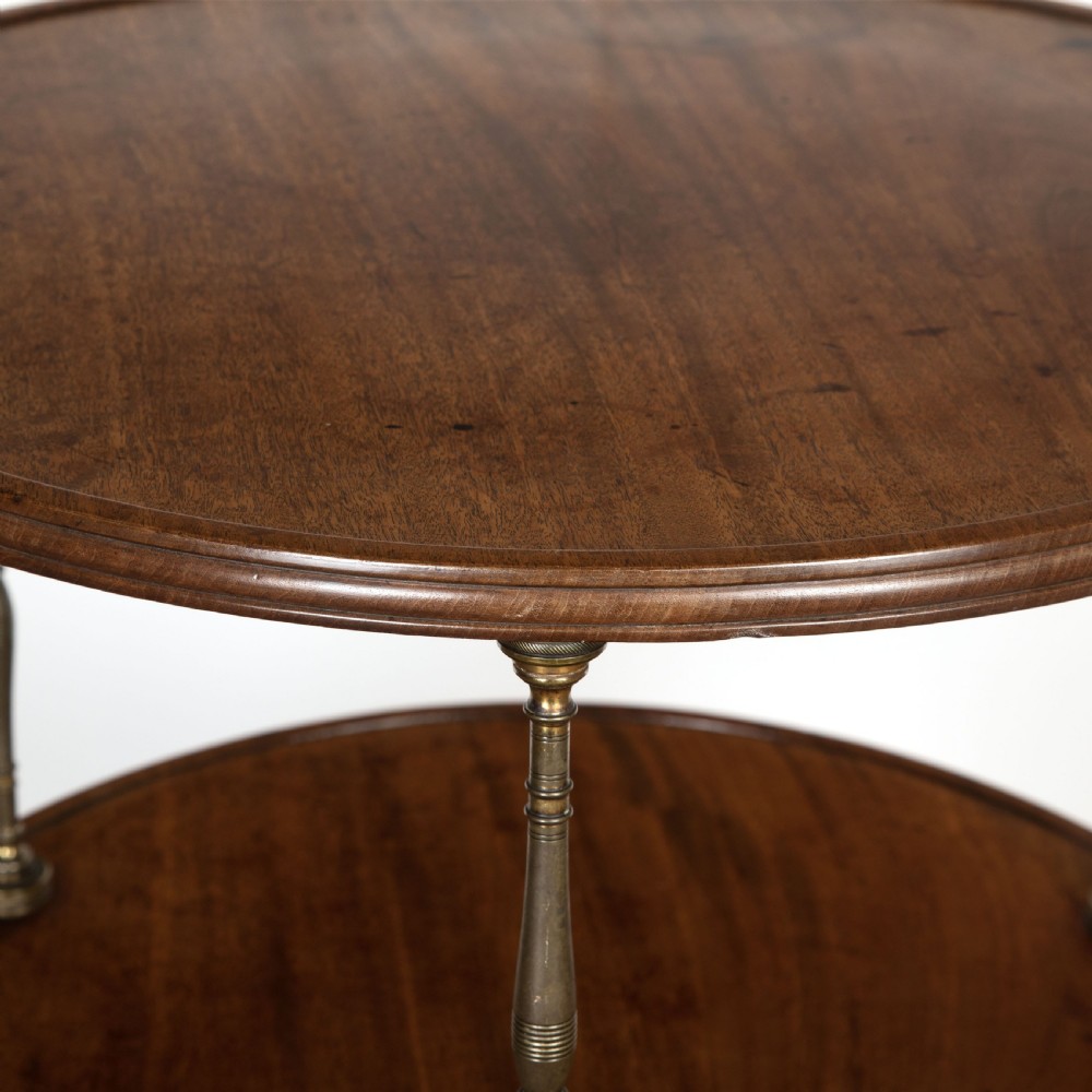 A two-tiered dark mahogany dumbwaiter featuring brass support columns, a fluted central pedestal, and a carved tripod base with paw feet. View VI
