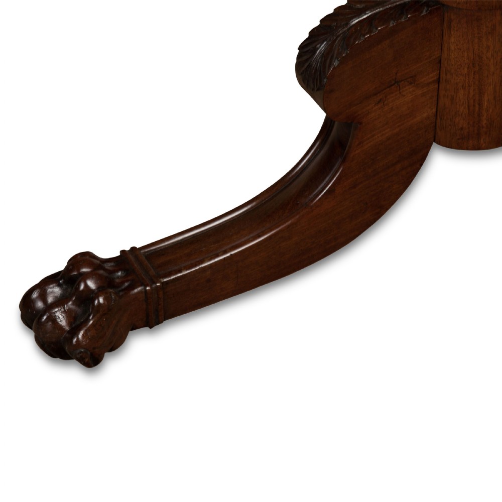 A two-tiered dark mahogany dumbwaiter featuring brass support columns, a fluted central pedestal, and a carved tripod base with paw feet. View X