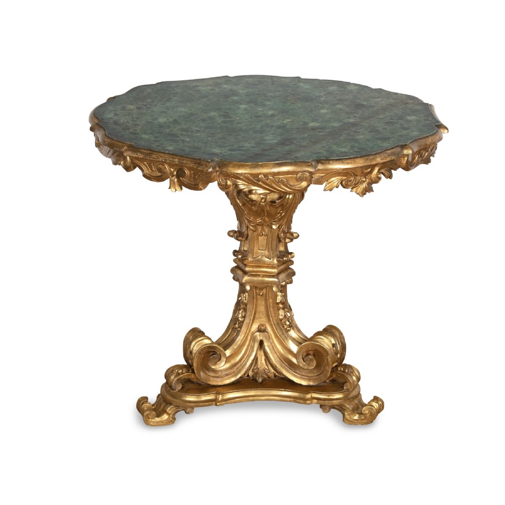 A 19th-century Italian centre table featuring a scalloped green marble top set upon a heavily carved giltwood pedestal base with scroll legs.