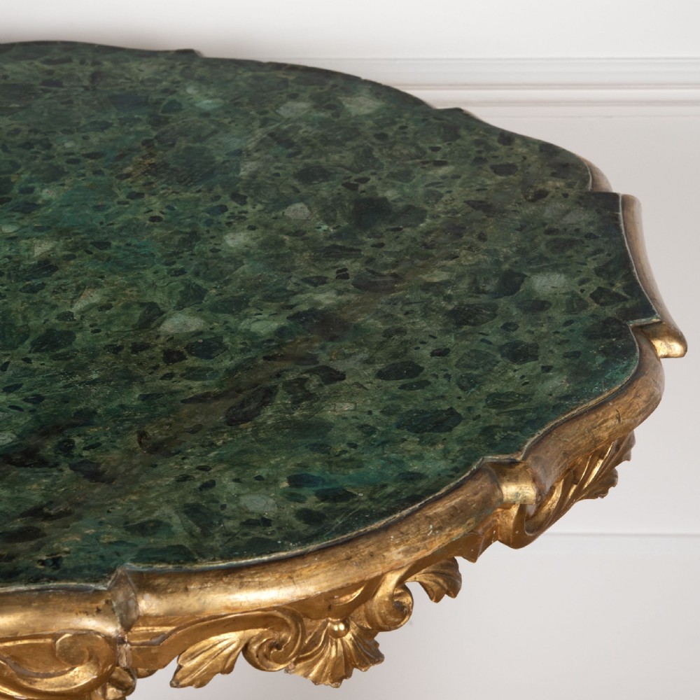 A 19th-century Italian centre table featuring a scalloped green marble top set upon a heavily carved giltwood pedestal base with scroll legs. View III