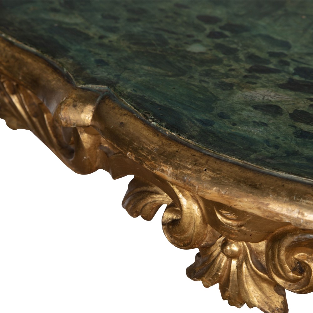 A 19th-century Italian centre table featuring a scalloped green marble top set upon a heavily carved giltwood pedestal base with scroll legs. View IV
