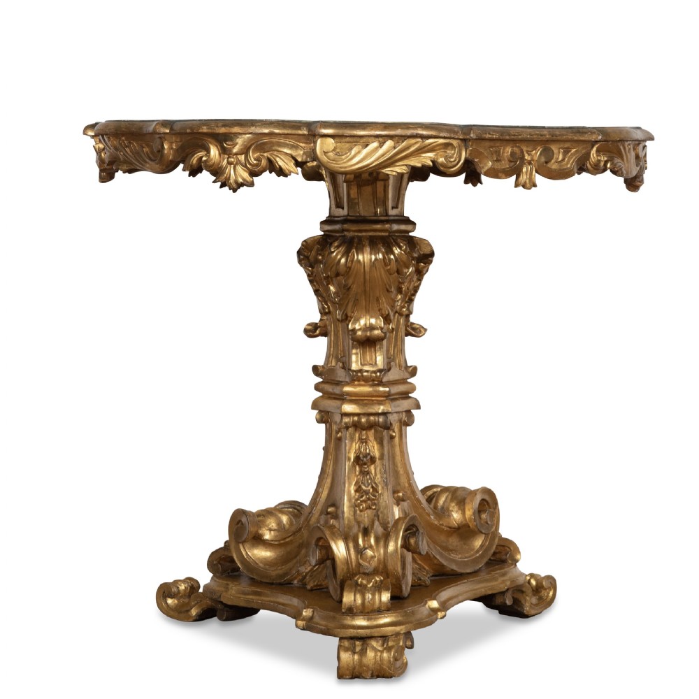 A 19th-century Italian centre table featuring a scalloped green marble top set upon a heavily carved giltwood pedestal base with scroll legs. View VI