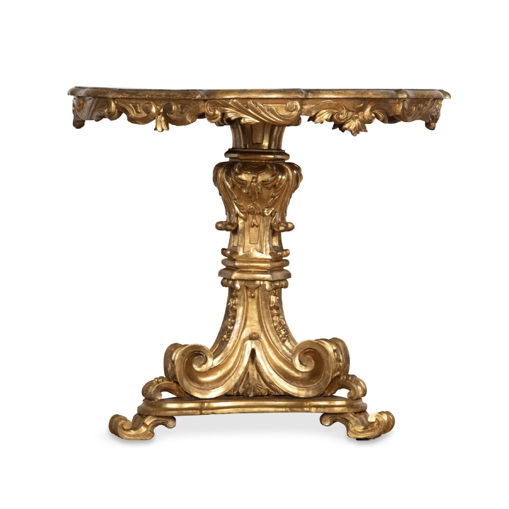 A 19th-century Italian centre table featuring a scalloped green marble top set upon a heavily carved giltwood pedestal base with scroll legs. View VII