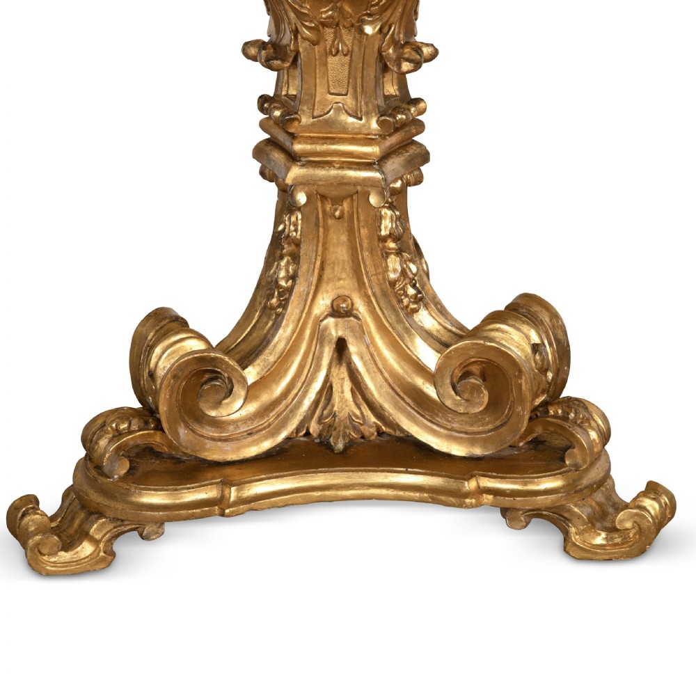 A 19th-century Italian centre table featuring a scalloped green marble top set upon a heavily carved giltwood pedestal base with scroll legs. View XI