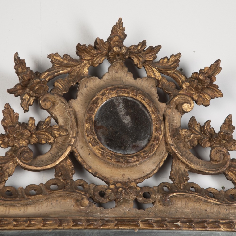 A rectangular eighteenth-century Italian giltwood wall mirror featuring a carved floral crest with an oval medallion and silvered glass. View III