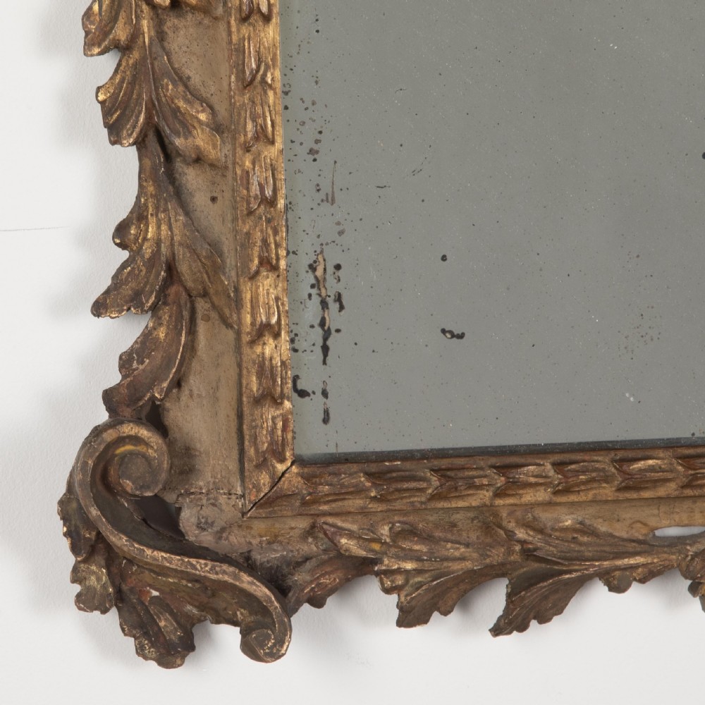 A rectangular eighteenth-century Italian giltwood wall mirror featuring a carved floral crest with an oval medallion and silvered glass. View VI