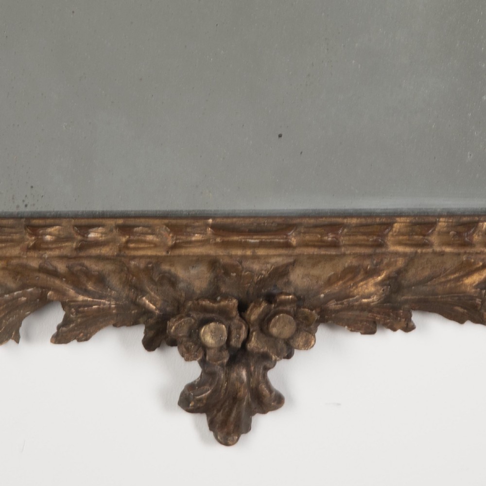 A rectangular eighteenth-century Italian giltwood wall mirror featuring a carved floral crest with an oval medallion and silvered glass. View VIII