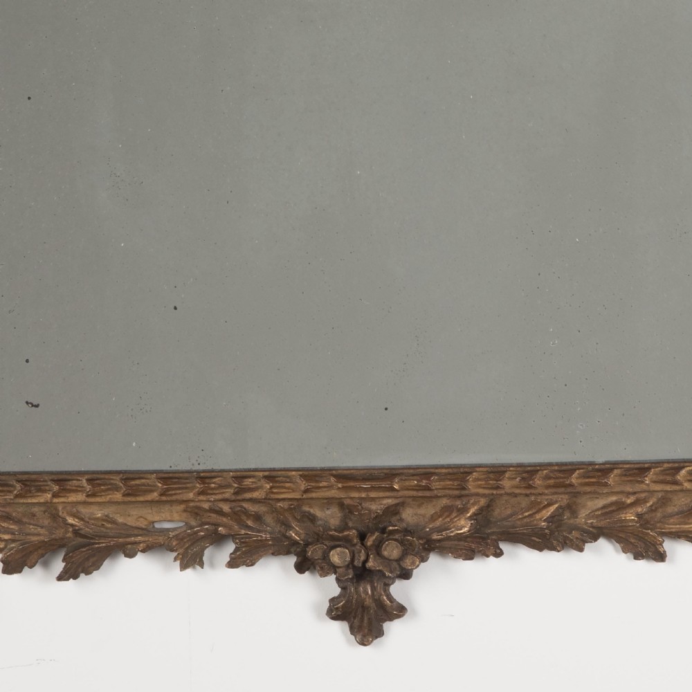 A rectangular eighteenth-century Italian giltwood wall mirror featuring a carved floral crest with an oval medallion and silvered glass. View IX