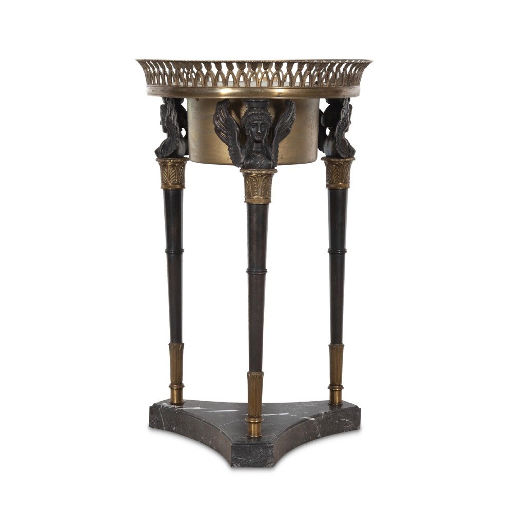 A 19th-century French Empire bronze Athenienne featuring a pierced metal gallery, winged caryatid legs, and a triangular dark marble base. View II