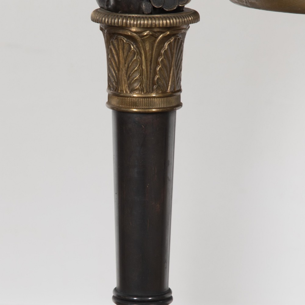 A 19th-century French Empire bronze Athenienne featuring a pierced metal gallery, winged caryatid legs, and a triangular dark marble base. View IX