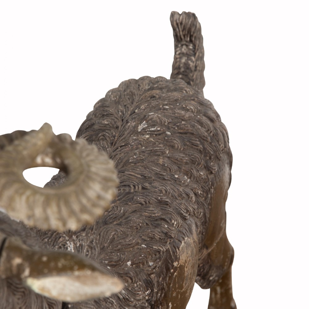 A 19th-century life-size hand-carved wooden goat sculpture with curved horns and a distressed brown painted finish. View VI
