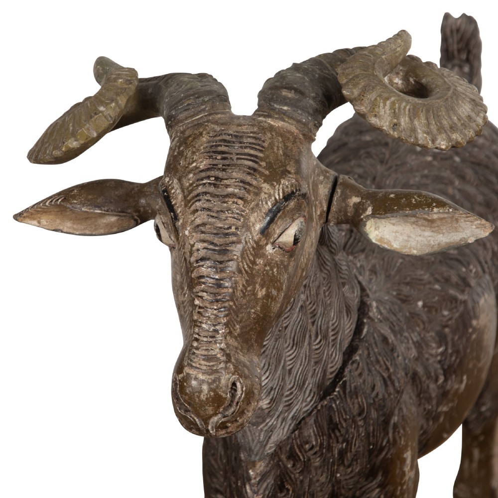 A 19th-century life-size hand-carved wooden goat sculpture with curved horns and a distressed brown painted finish. View VII