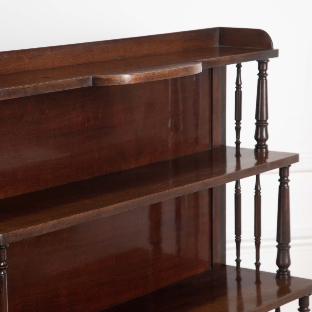 A matching pair of dark brown 19th-century Regency mahogany open bookcases featuring four tiers supported by turned side spindles. View VI