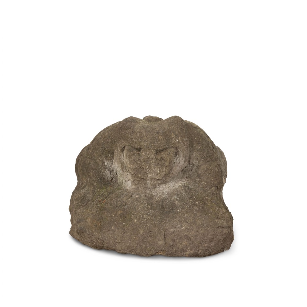 A hand-carved grey stone sculpture depicting a sitting frog with weathered surface textures. View III