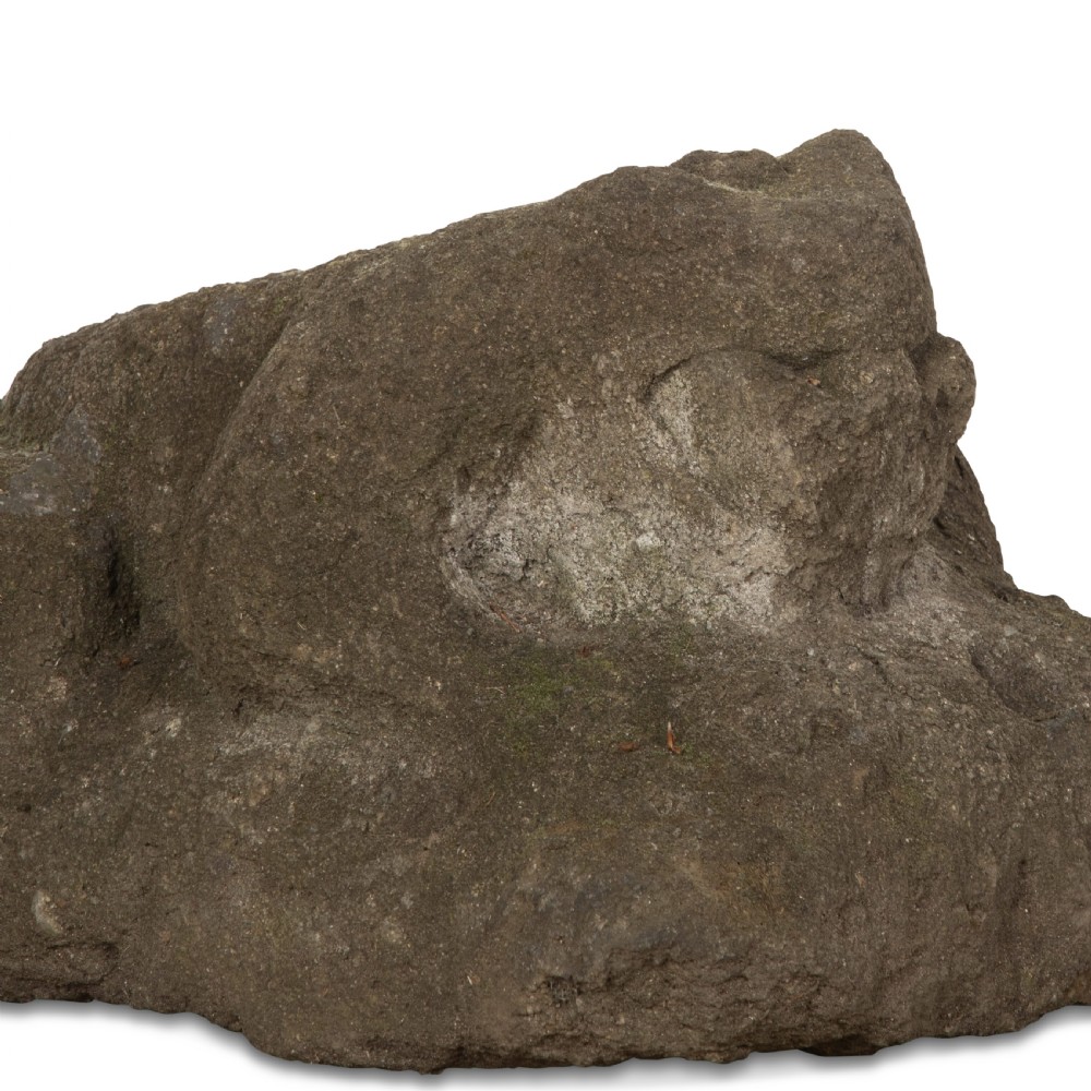 A hand-carved grey stone sculpture depicting a sitting frog with weathered surface textures. View VII