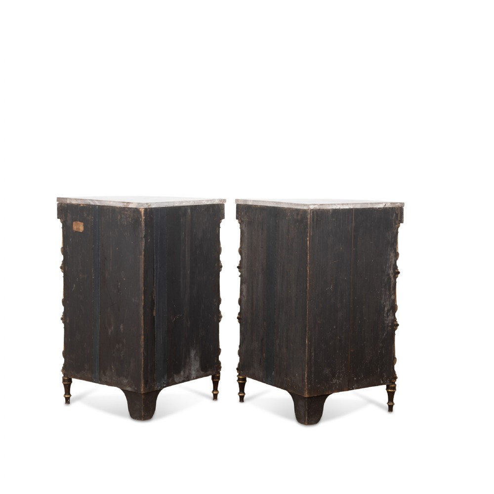 A pair of Regency-style black painted open corner cabinets featuring marble tops, gilt floral scrollwork friezes, and turned support columns. View XIV