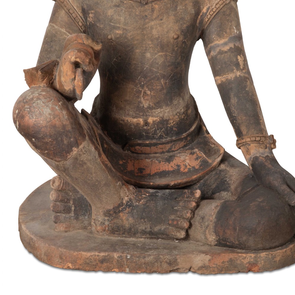 A 19th-century Khmer terracotta figure depicted in a seated pose with traditional attire and a high crown. View III