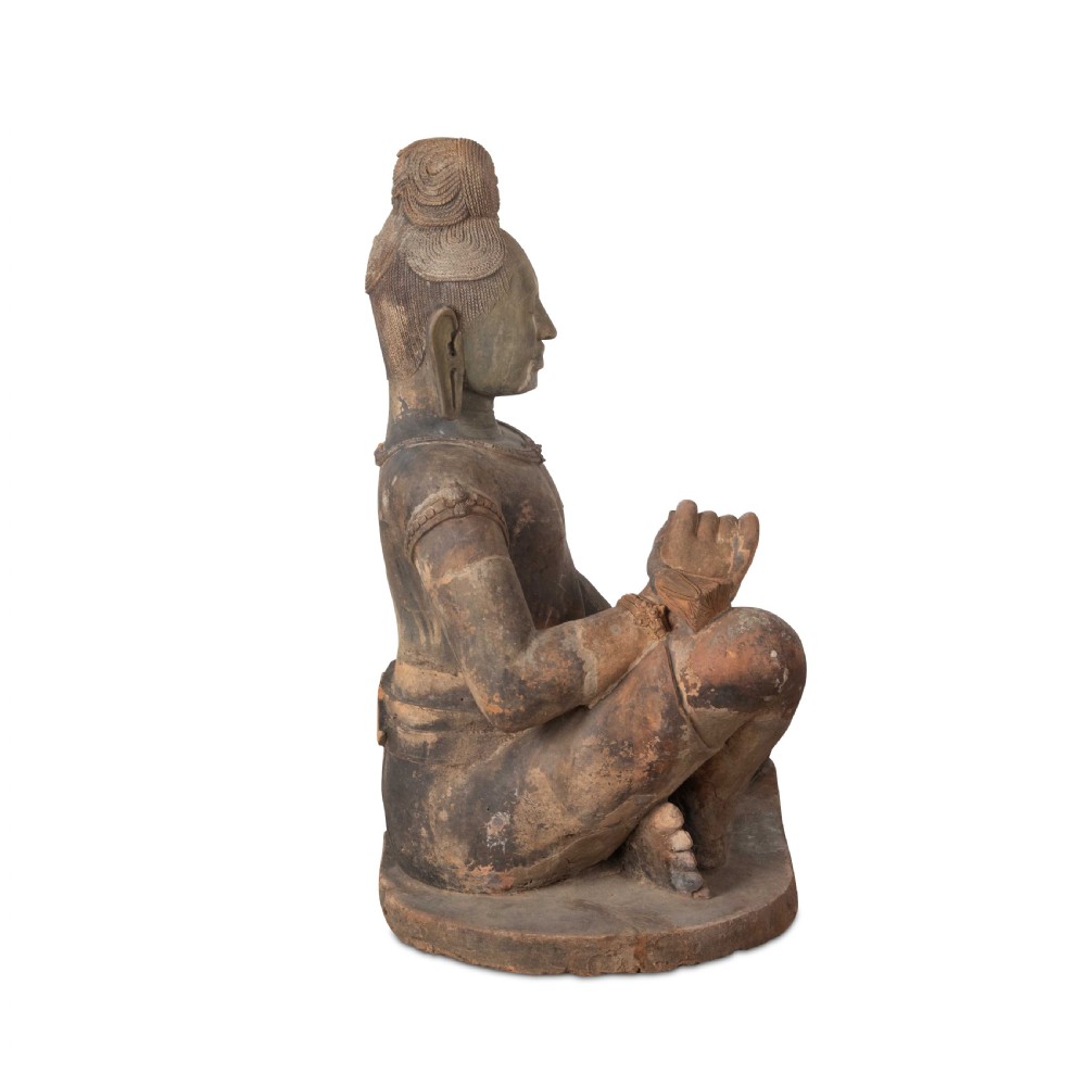A 19th-century Khmer terracotta figure depicted in a seated pose with traditional attire and a high crown. View IV