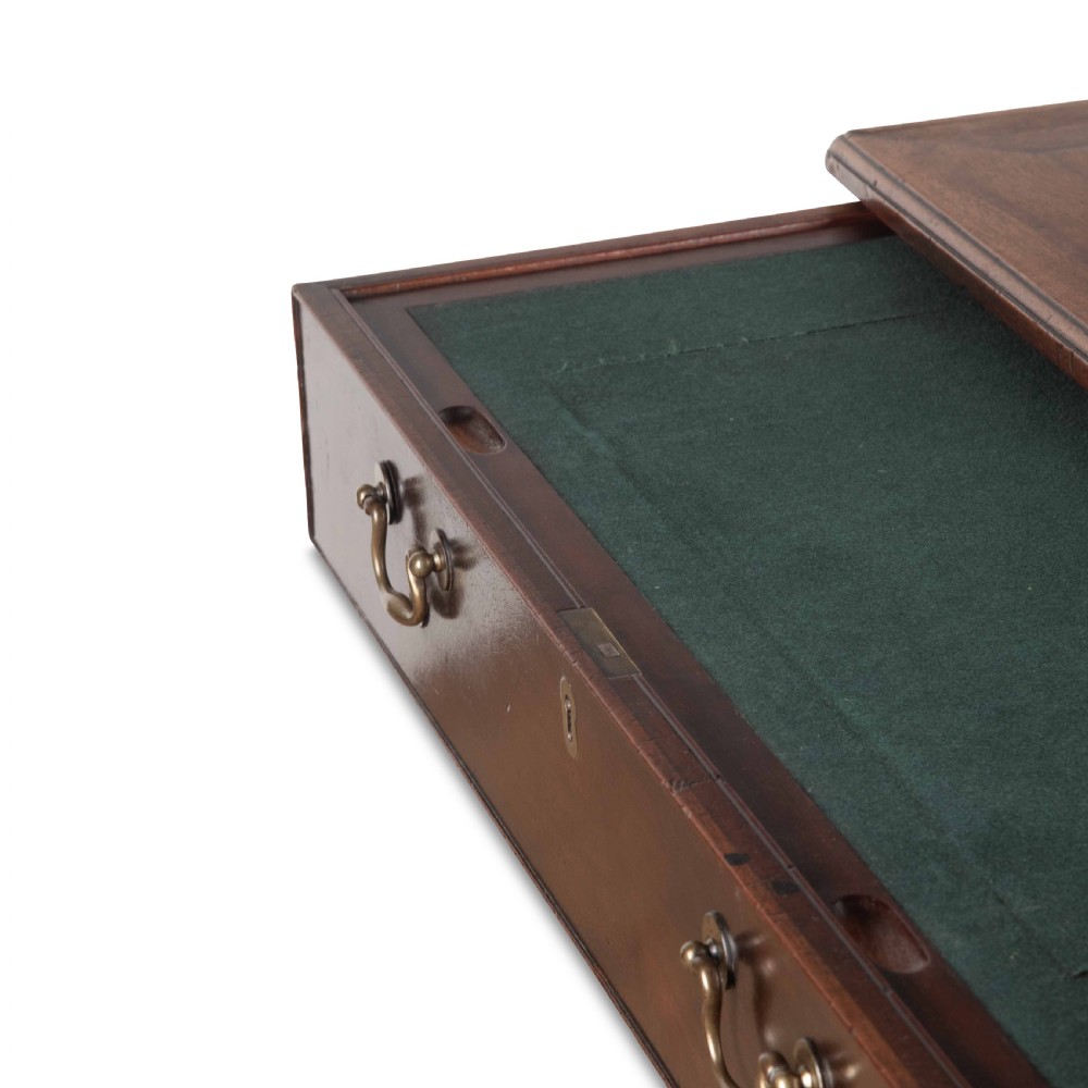 An 18th-century dark mahogany kneehole desk featuring a long top drawer above six side drawers and a central recessed cupboard door with brass handles. View XI