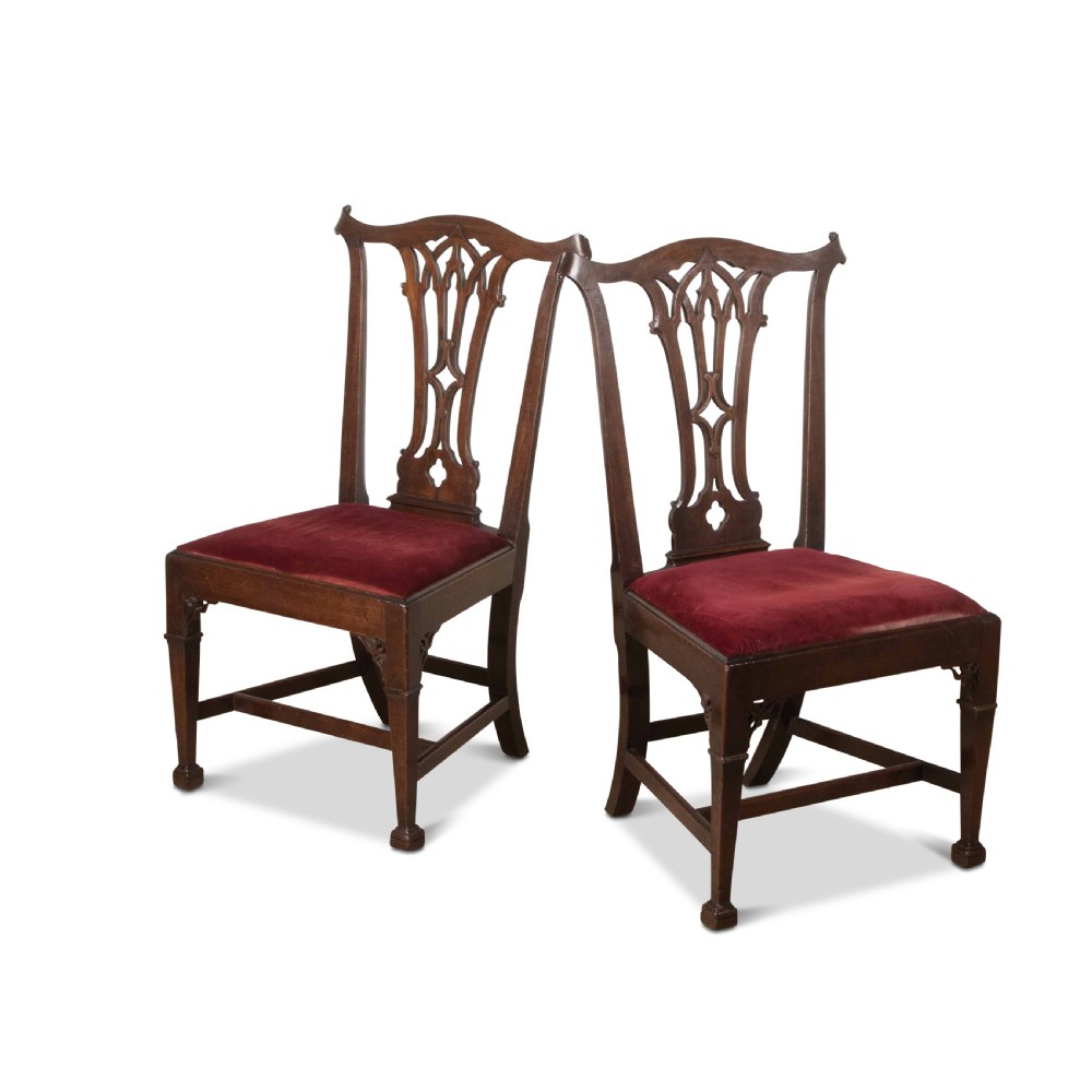 A pair of 18th-century mahogany side chairs featuring pierced Gothic tracery splats and red velvet upholstered seats. View II