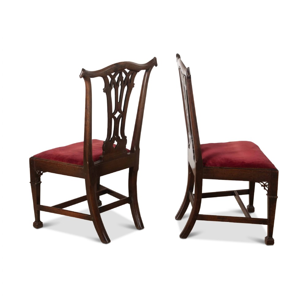 A pair of 18th-century mahogany side chairs featuring pierced Gothic tracery splats and red velvet upholstered seats. View IV