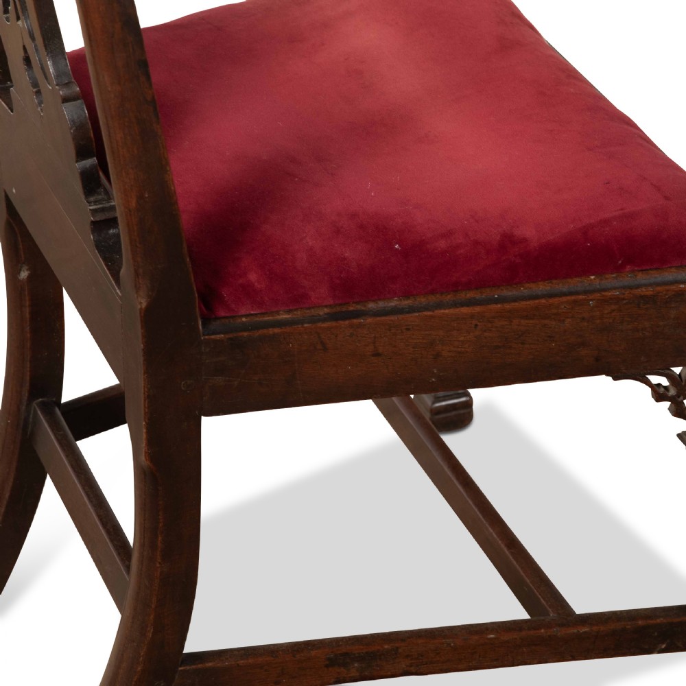 A pair of 18th-century mahogany side chairs featuring pierced Gothic tracery splats and red velvet upholstered seats. View VII