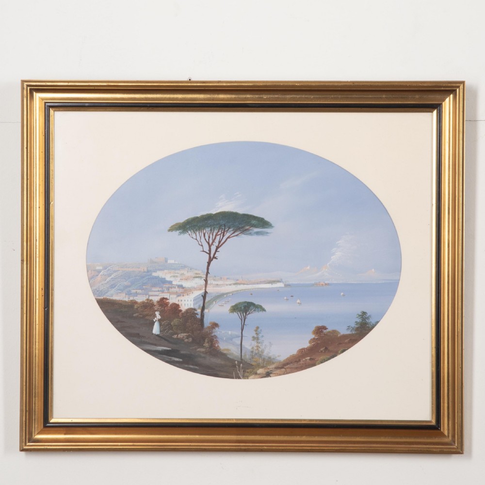A pair of 19th-century gilt-framed landscape paintings depicting oval coastal views of the Bay of Naples in gouache on paper. View II