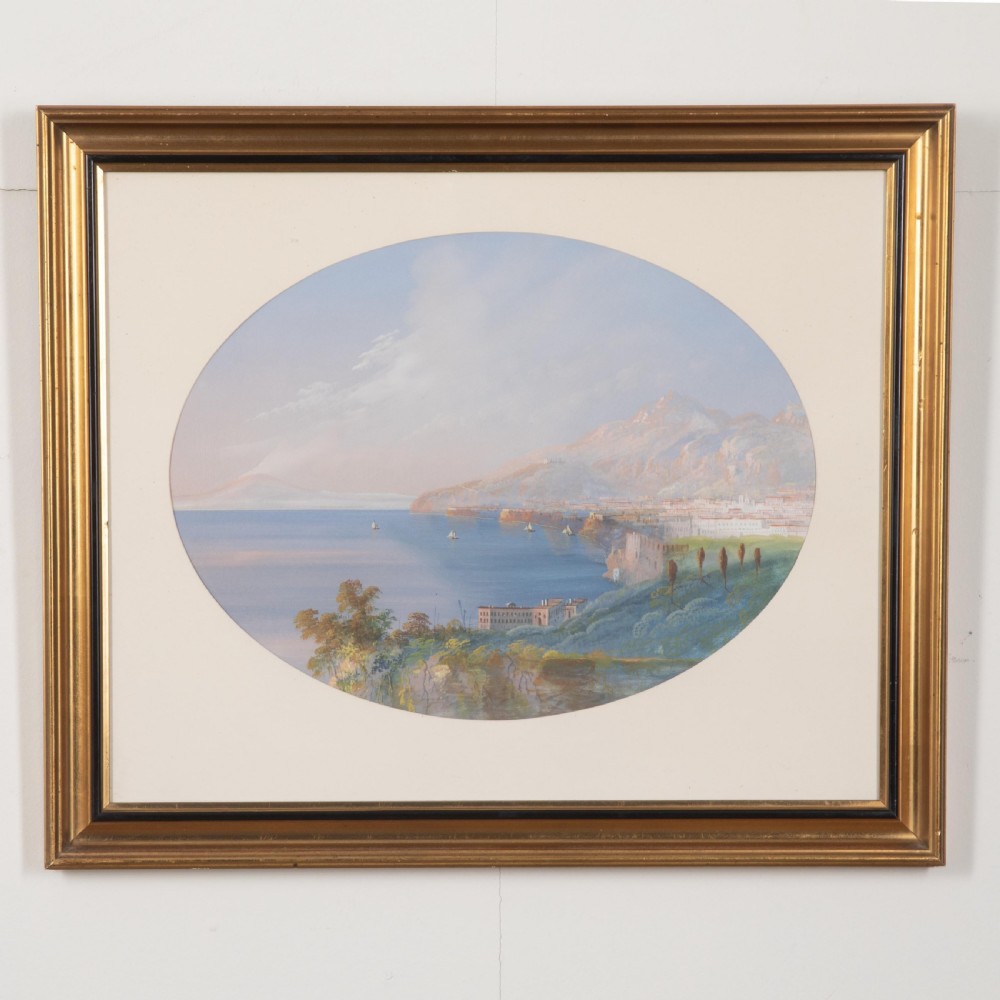 A pair of 19th-century gilt-framed landscape paintings depicting oval coastal views of the Bay of Naples in gouache on paper. View III