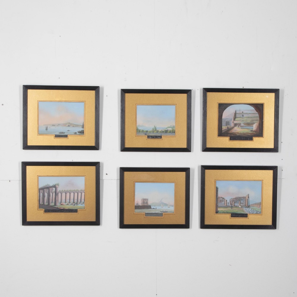 A set of six 19th-century framed gouache paintings depicting Italian classical ruins and coastal views with gold mounts and black frames.