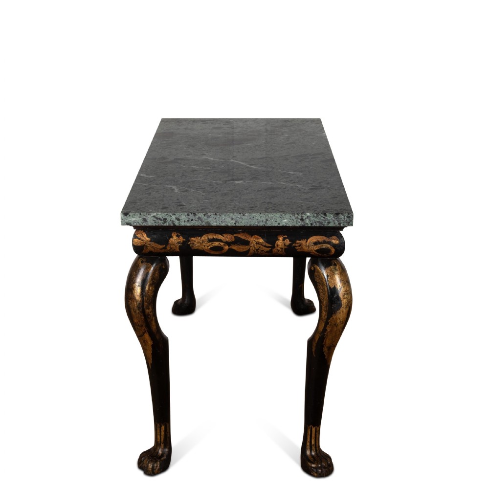 A Regency style ebonised and gilt Chinoiserie console table featuring a grey-green marble top and carved cabriole legs with paw feet. View III