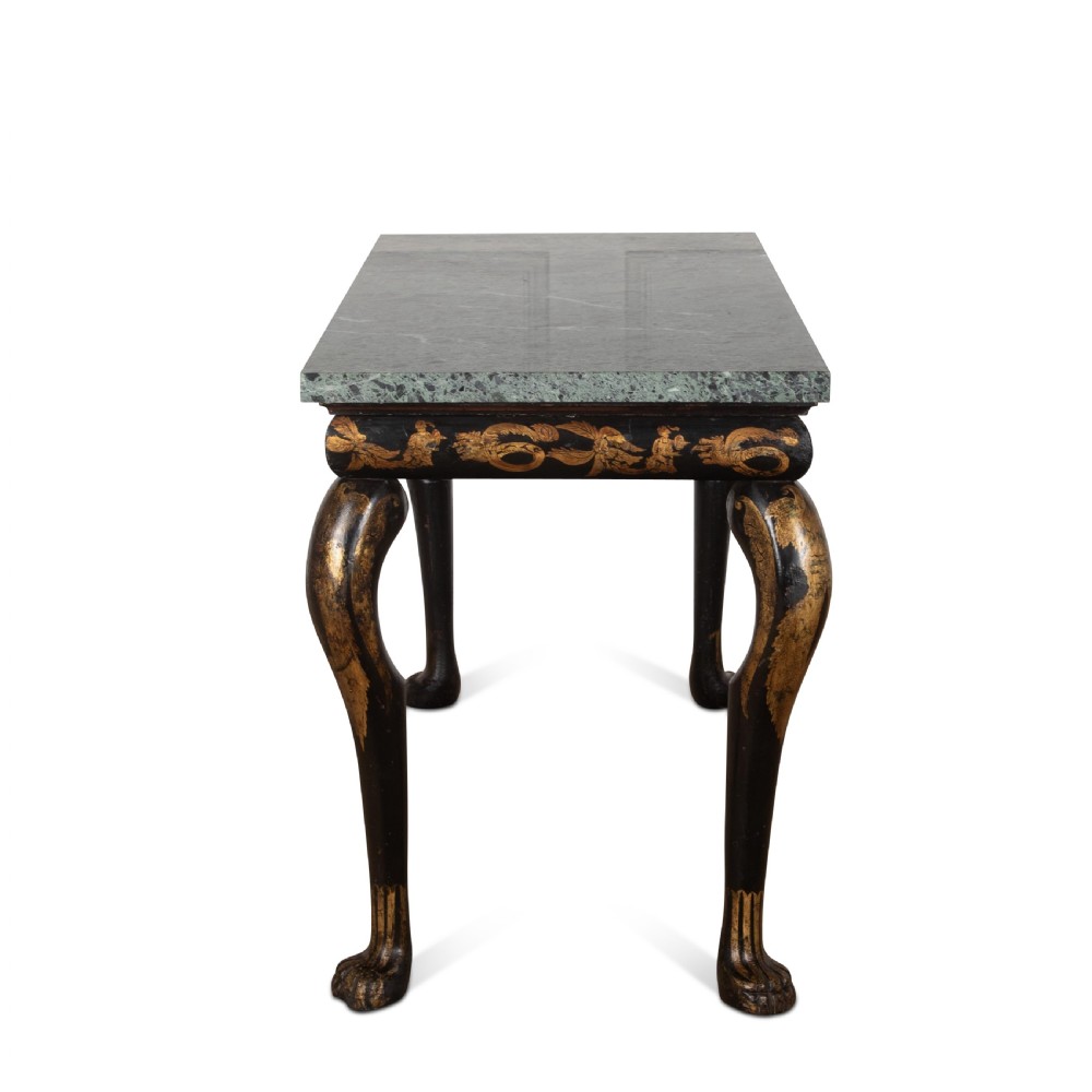 A Regency style ebonised and gilt Chinoiserie console table featuring a grey-green marble top and carved cabriole legs with paw feet. View IV