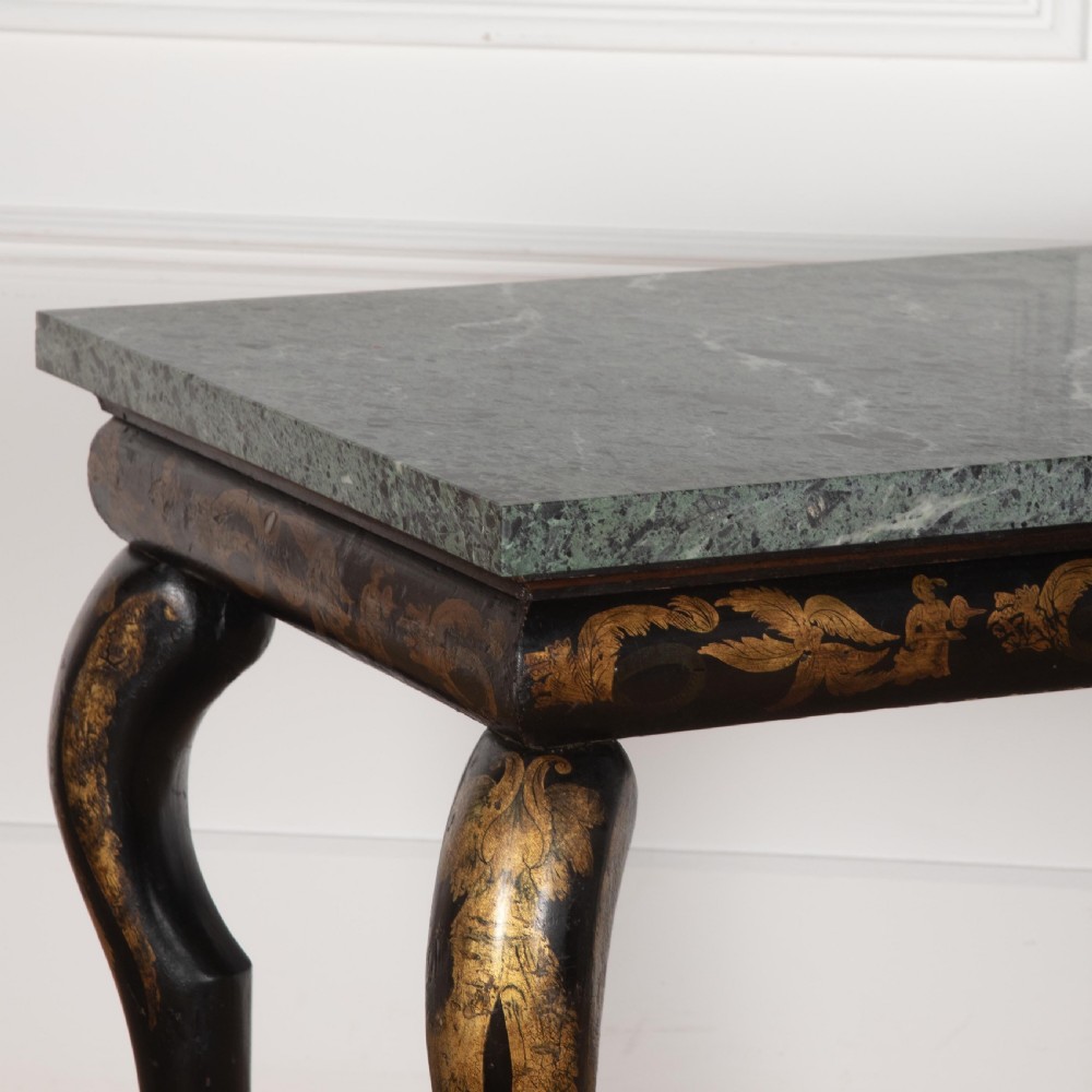 A Regency style ebonised and gilt Chinoiserie console table featuring a grey-green marble top and carved cabriole legs with paw feet. View VI