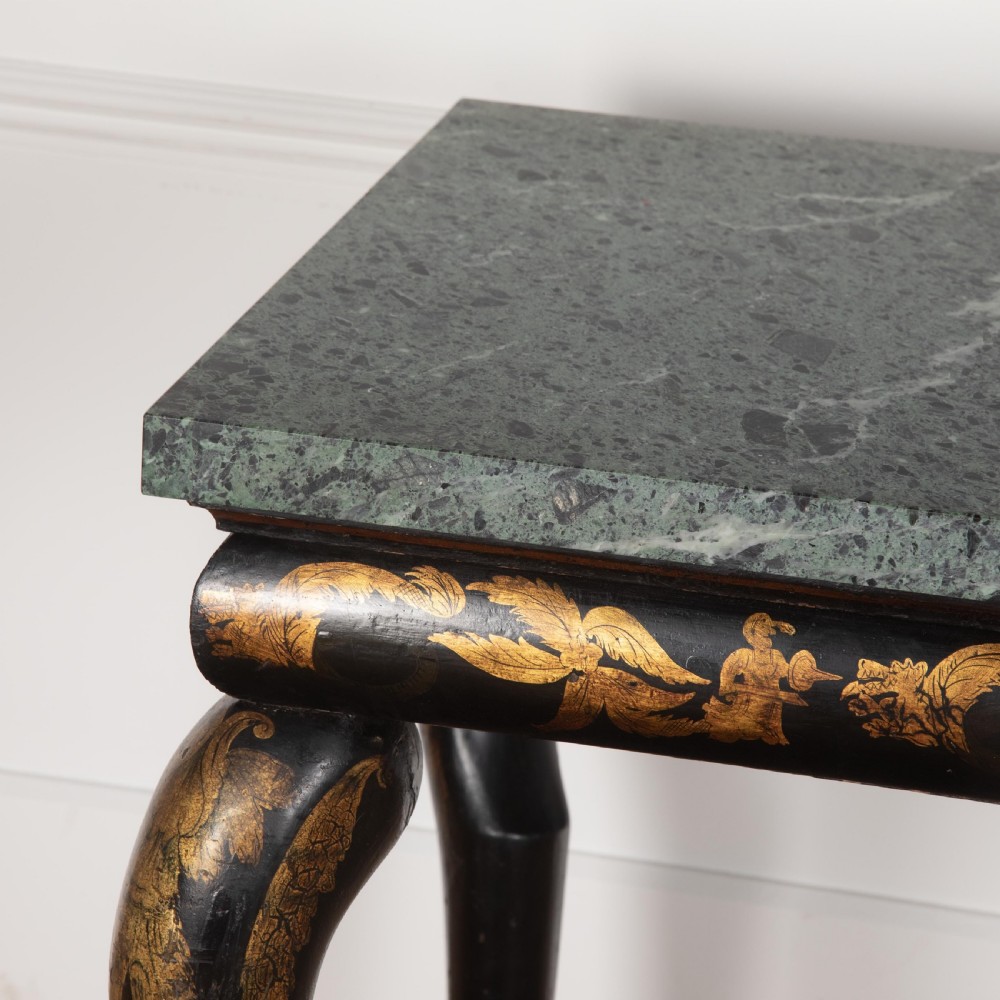 A Regency style ebonised and gilt Chinoiserie console table featuring a grey-green marble top and carved cabriole legs with paw feet. View IX