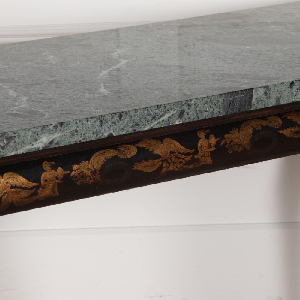 A Regency style ebonised and gilt Chinoiserie console table featuring a grey-green marble top and carved cabriole legs with paw feet. View XI
