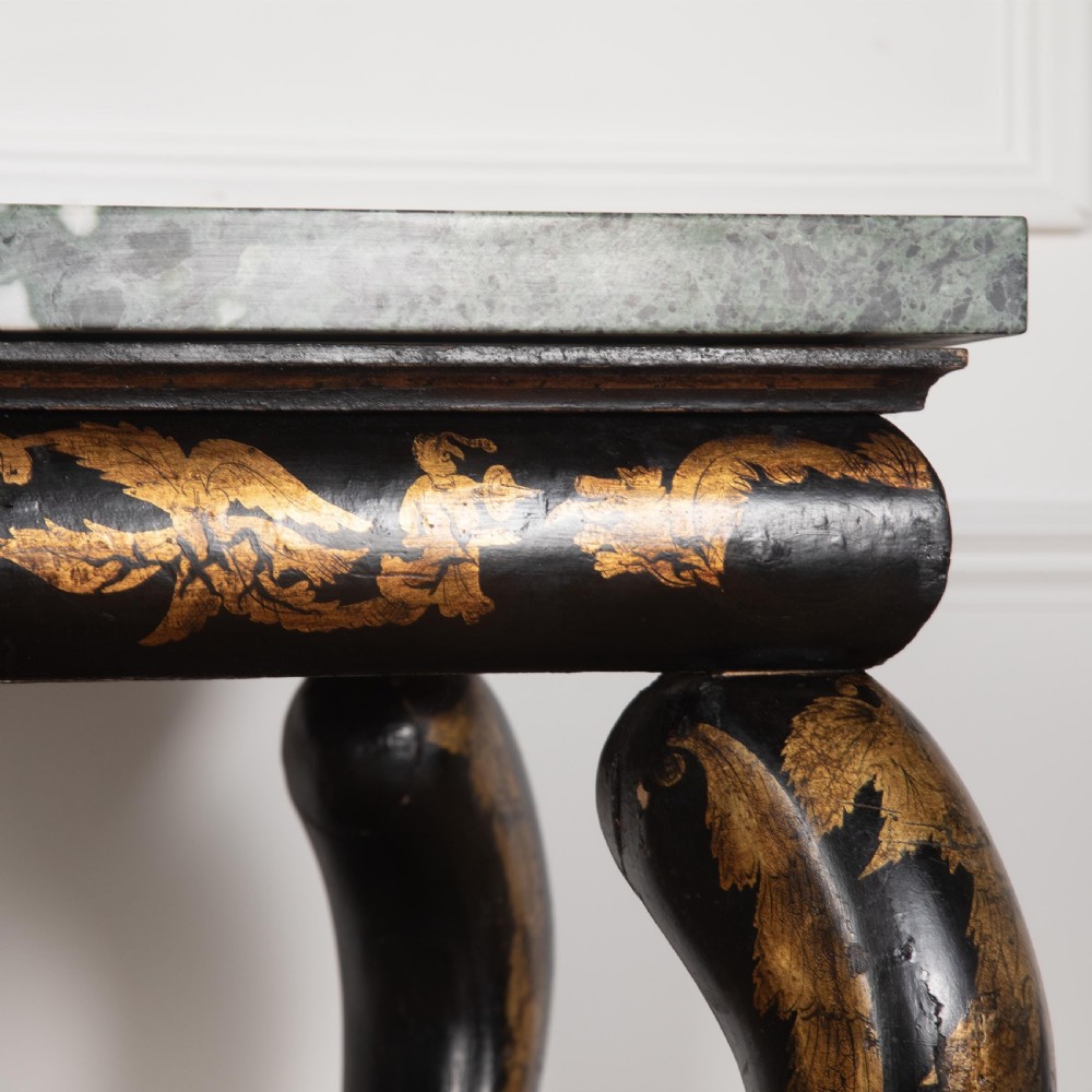 A Regency style ebonised and gilt Chinoiserie console table featuring a grey-green marble top and carved cabriole legs with paw feet. View XII