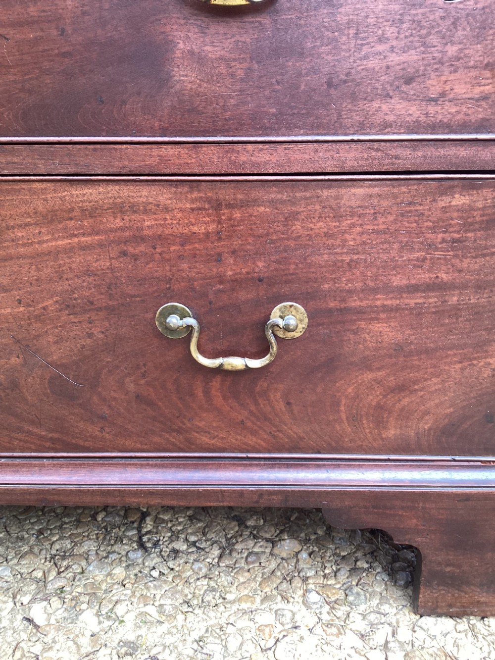A pair of antique George II mahogany chests on chests featuring brass swan-neck handles and raised bracket feet. View XII